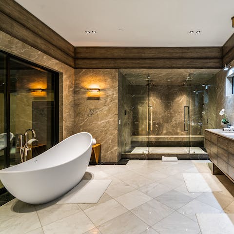 Treat yourself to some well-earned me-time in the sleek bathtub