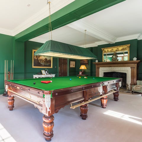 Challenge a friend to a game of billiard in the evergreen games room