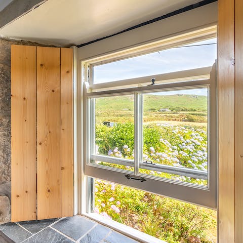 Wake up to stunning vistas of Cornish meadows set against the sea