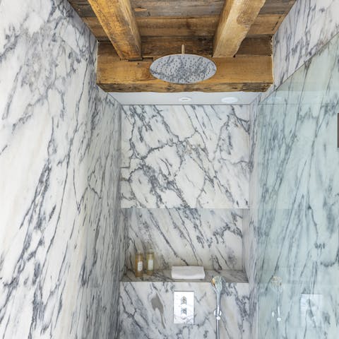 Freshen up in the stunning marble-clad bathroom