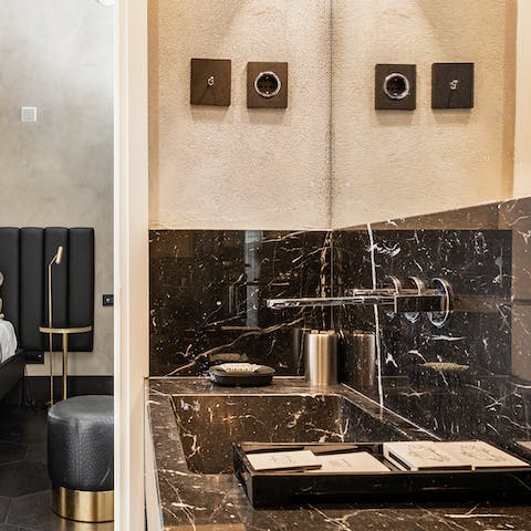 Wash away the day's exertions in your black marble bathroom