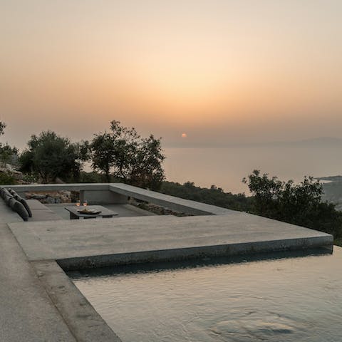 Sip a glass of ouzo on the terrace as the sun falls beneath the horizon