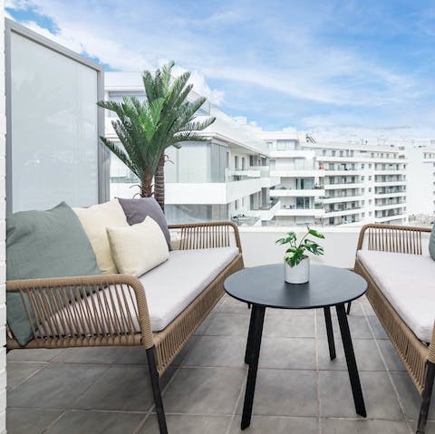 Relax with a cold drink on the balcony's sofas