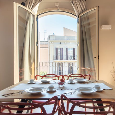 Sit down to a meal at the elegant table, framed by Juliet balcony views of Sant Antoni 