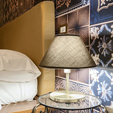 Get a restful night's sleep in the cosy bedrooms with warm bedside lighting and quirky wallpaper prints