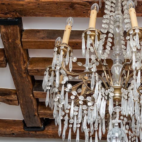 Admire the home's characterful beams & full-size chandelier