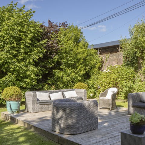 Relax out in the sun in the home's large garden