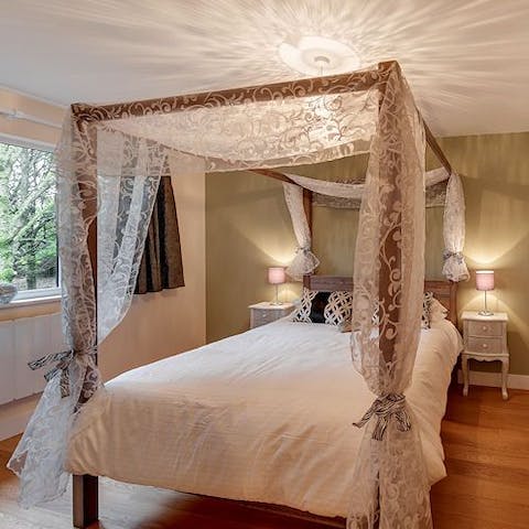 Enjoy sweet dreams in your elegant four-poster bed
