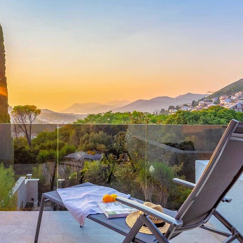 Watch the sunset over the mountains from your balcony