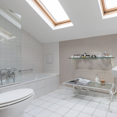 Enjoy a relaxing bath in the main bedroom's skylit en-suite