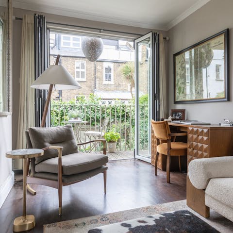 Balance work and rest in the living room, leading out to a balcony