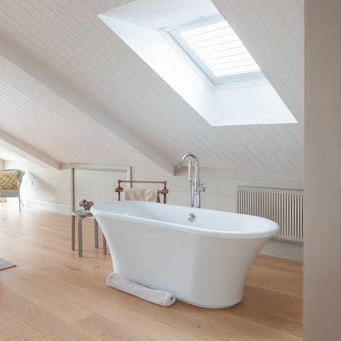 Unwind in the free-standing bathtub amidst the tranquil bedroom setting