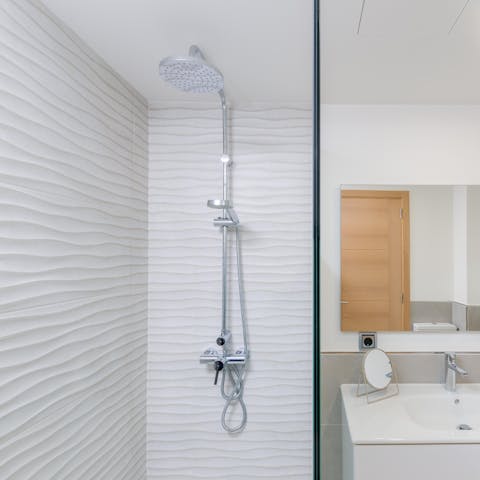 Wash off the day at the beach under the luxurious rainfall showers
