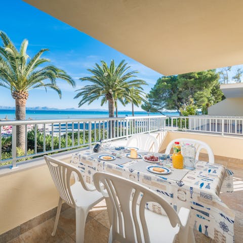 Enjoy an alfresco breakfast on the private balcony while feasting on palm-fringed beach views