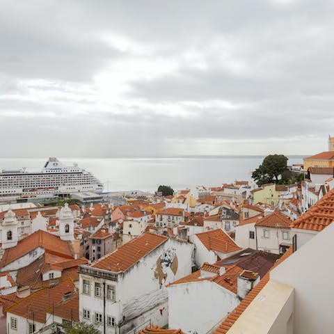 Admire the incredible balcony view across the city to the Tagus River