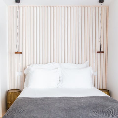 Snuggle into bed under the minimalist wooden bedframe