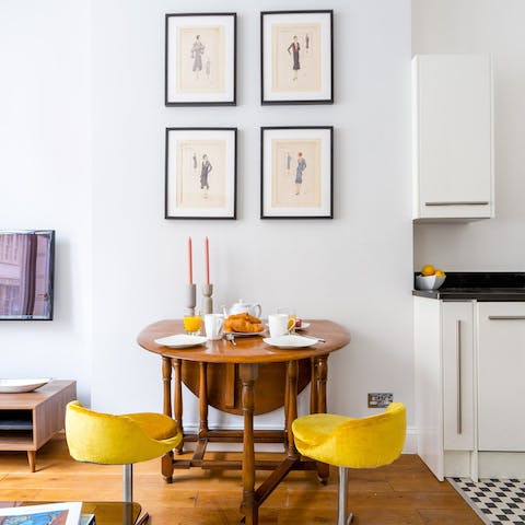 Sit down for breakfast in a stylish dining area with tasteful artwork 