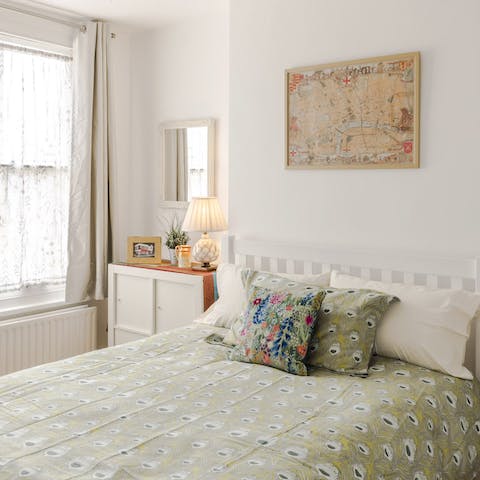 Relax among the soothing greens and floral prints in the cosy bedroom