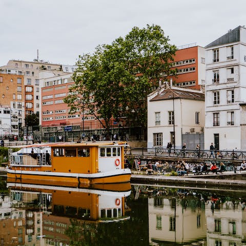 Watch the world pass by from the banks of the Canal Saint-Martin