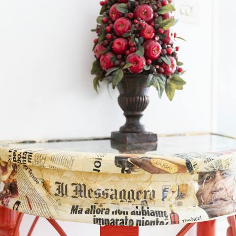 The newspaper-patterned side table