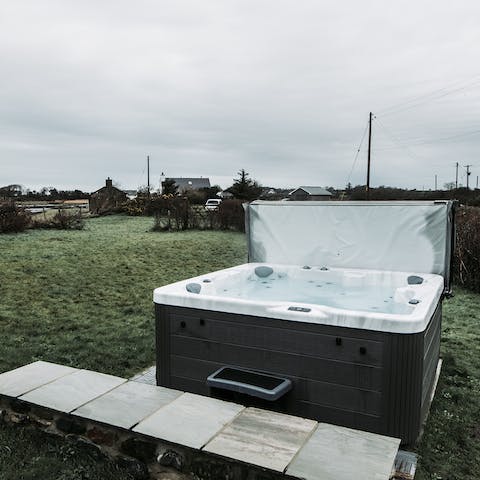 Sit back and relax in the best seat in the house — the hot tub in the garden