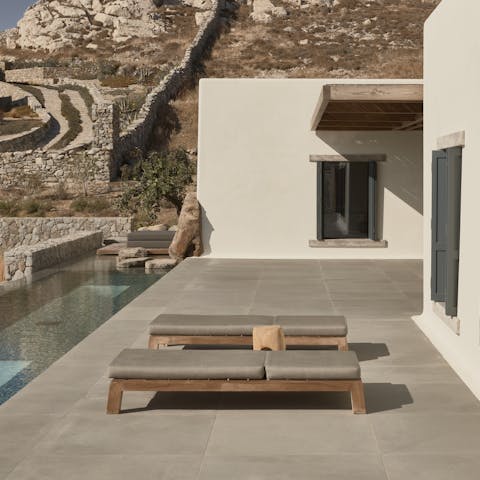 Cross the stepping stones through the shallows of the pool to the main outdoor terrace