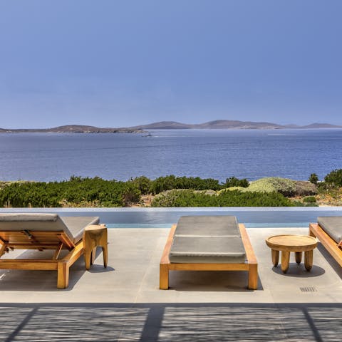 Take in the stunning views of the island of Delos from the infinity pool