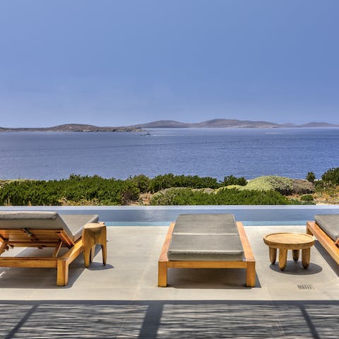 Take in the stunning views of the island of Delos from the infinity pool