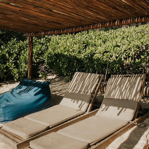 Spend days relaxing on the private sun loungers on the sandy beach