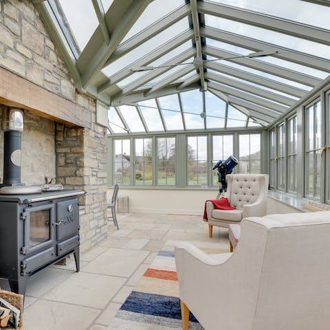 Retire to the orangery and inspect the night sky through the telescope