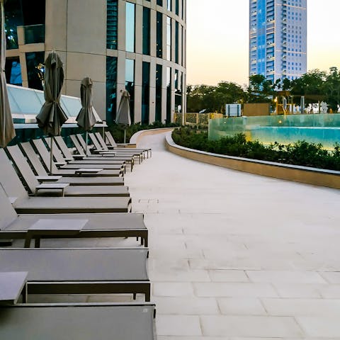 Soak up some sun by the shared pool, complemented by Burj Khalifa views