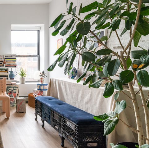 Admire the houseplants and unique items of furniture dotted throughout the apartment
