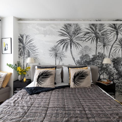 Dream of tropical shores in the elegant bed framed by a palm feature wall