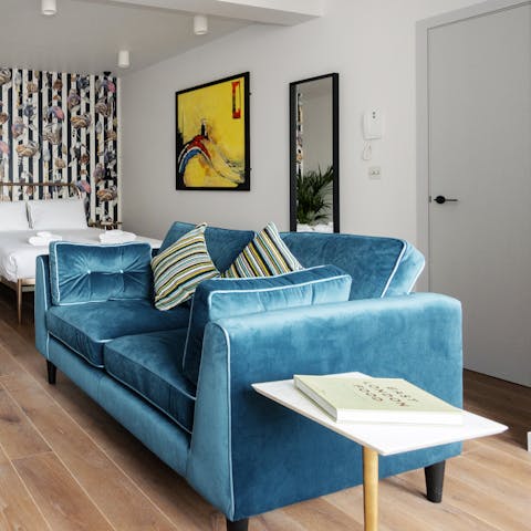 Mix a gin and tonic and get comfortable on the blue velvet sofa for a relaxed night in