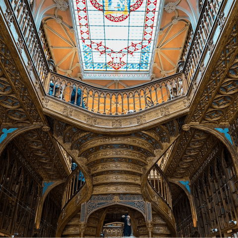 Browse the bookshelves at Livraria Lello, an eight-minute walk away