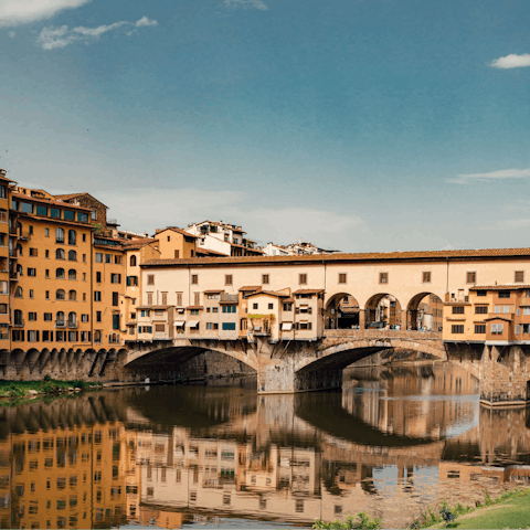 Stroll over to the nearby River Arno and cross the Ponte Vecchio