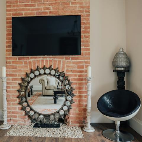 Admire quirky design features, like the oversized candle holders and mirror fireplace