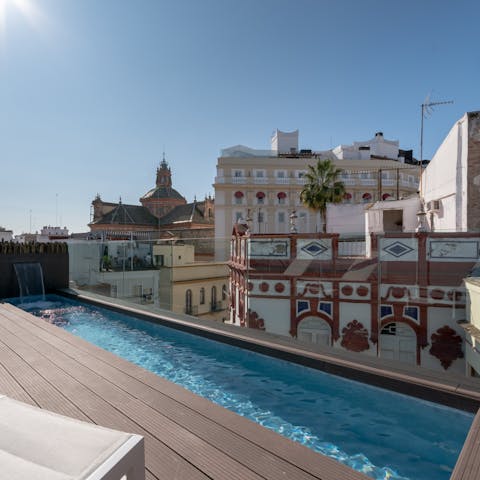 Plunge into the shared rooftop pool and admire the city views 