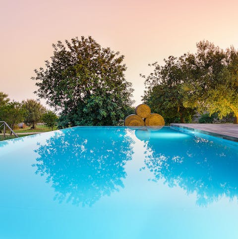 Take a dip in the pristine pool at dusk