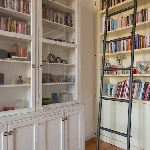 Peruse the floor-to-ceiling bookshelf for an engrossing read