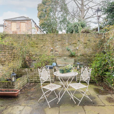 Catch the sun in the courtyard garden, a glass of wine in hand