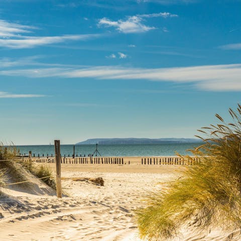 Soak up the sea air at West Wittering beach, eleven minutes away by car