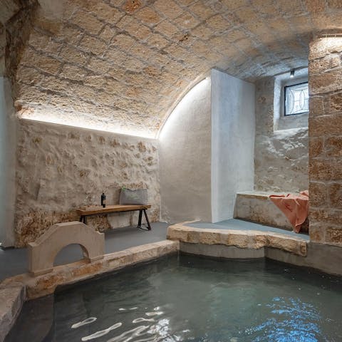 Relax and unwind in the waters of the building's communal spa bath