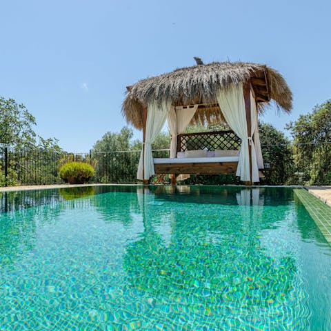 Chill out on the day bed by the private pool
