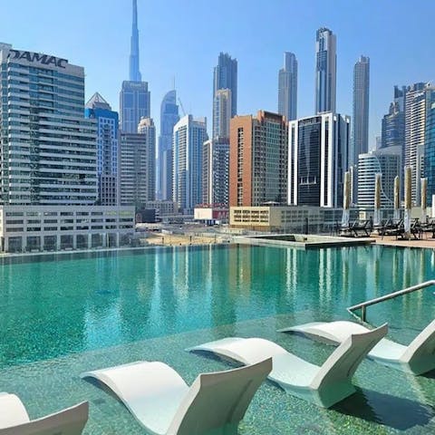Admire the skyscrapers from the shared pool