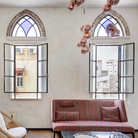 Throw open the original windows and relax in the boho living room with a cool breeze