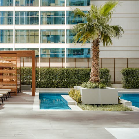 Relax by the communal swimming pool – will you swim or doze in a cabana?