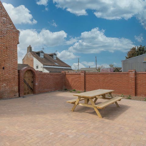 Unwind in the courtyard under the sunset as you sip on a glass of red