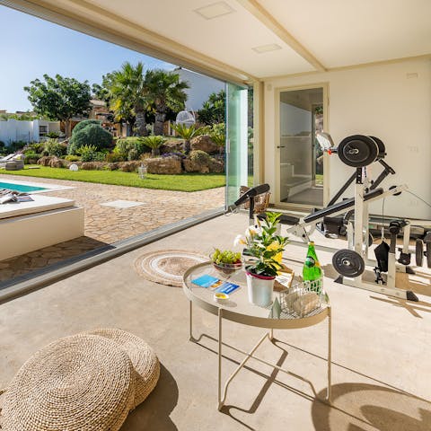 Have a good workout, with a view of the lush garden and the pool 