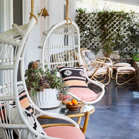 Take a peaceful moment for yourself in the hanging rattan chairs